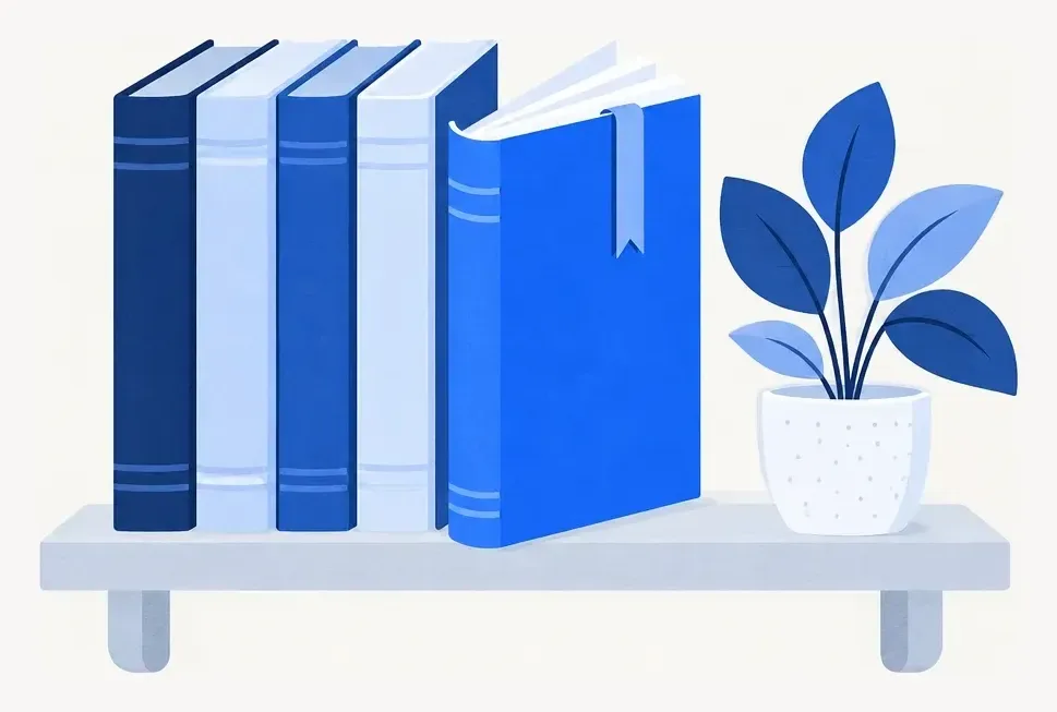 A shelf of slim blue guidebooks, one pulled forward and open with a bookmark, beside a small potted plant.